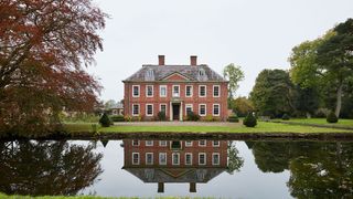 Image may contain Architecture Building Castle Nature Water Outdoors Fort Moat Land Plant Grass Pond and Housing