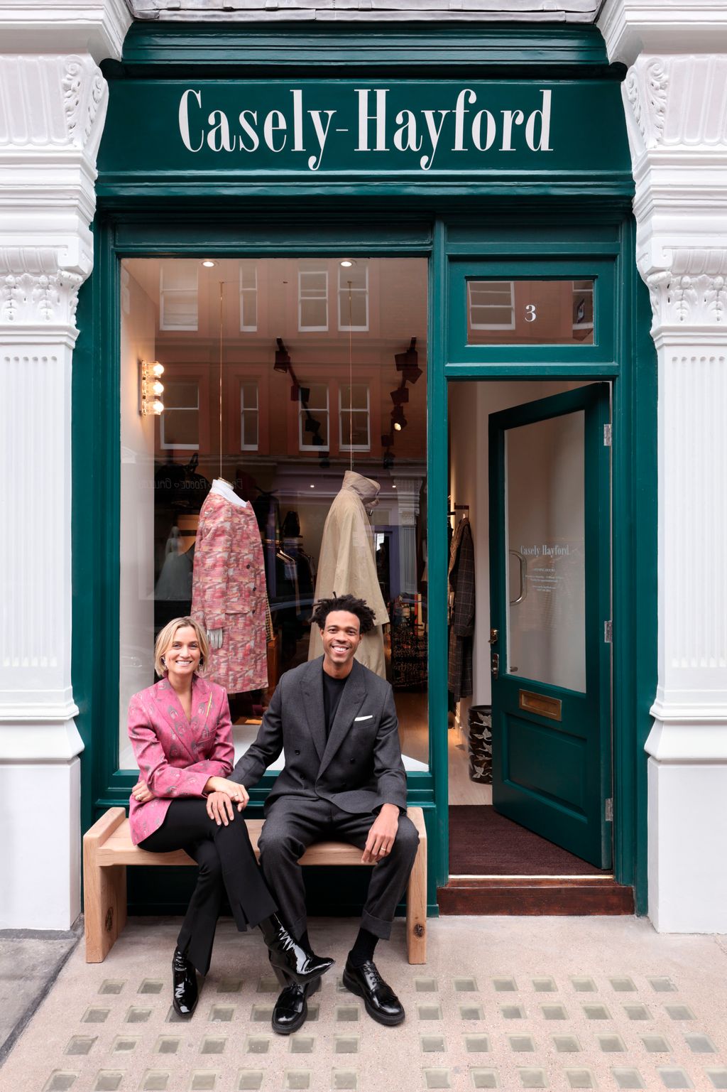 Image may contain Footwear Clothing Shoe Apparel Human Person Sitting Door and Pants