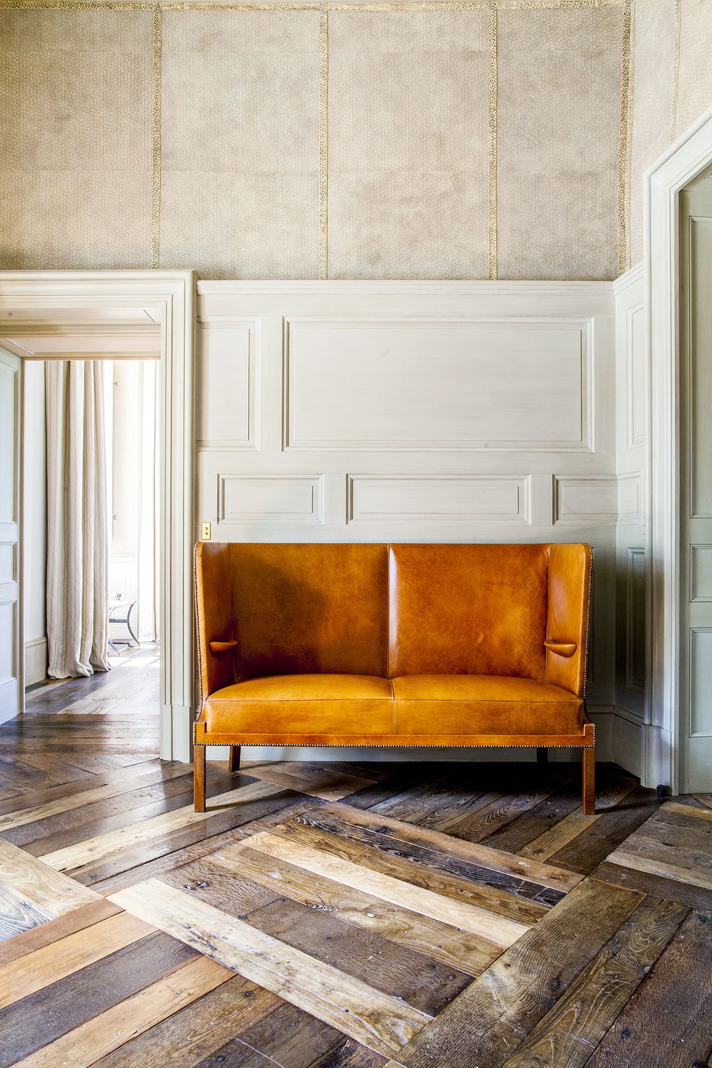 Image may contain Furniture Couch Wood Floor Flooring Hardwood Rug Living Room Room and Indoors