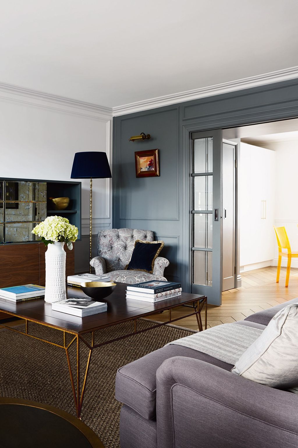 Image may contain Furniture Living Room Indoors Room Table Couch Interior Design Coffee Table and Rug