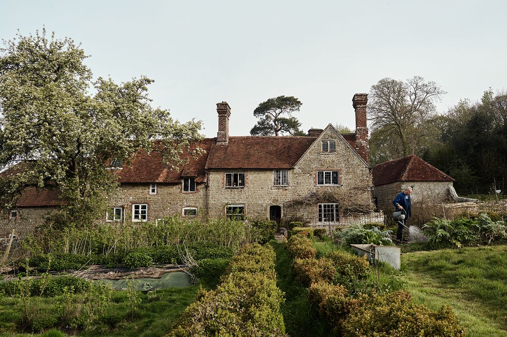 Woolhouse has a sandstone façade that dates back to the 17th century.    Ian is seen at work in the produce garden a...