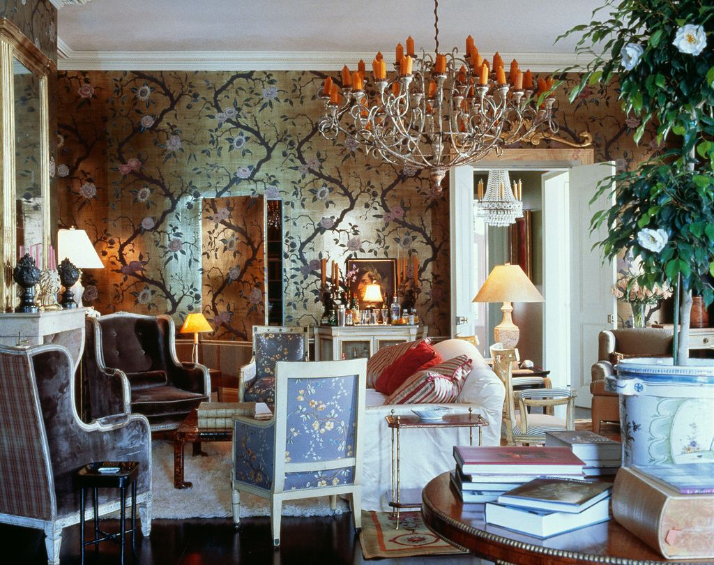 Image may contain Living Room Room Indoors Furniture Lamp Table Lamp Chair Couch Interior Design and Chandelier