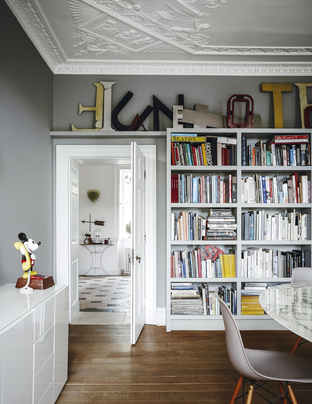 Image may contain Furniture Bookcase Shelf and Chair