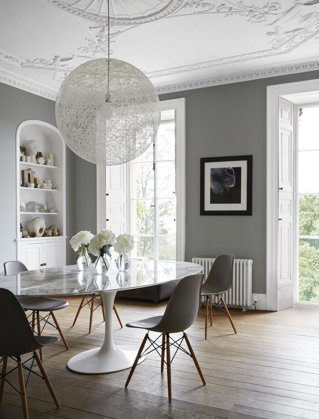 Mooois ‘Random Light hangs above a marbletopped Saarinen dining table from Knoll partnered with a set of original ‘Eames...
