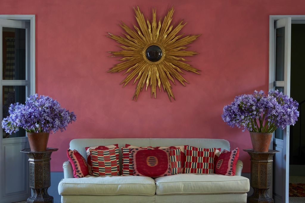 Image may contain Furniture Couch Living Room Room Indoors Plant Cushion Pillow Flower and Blossom