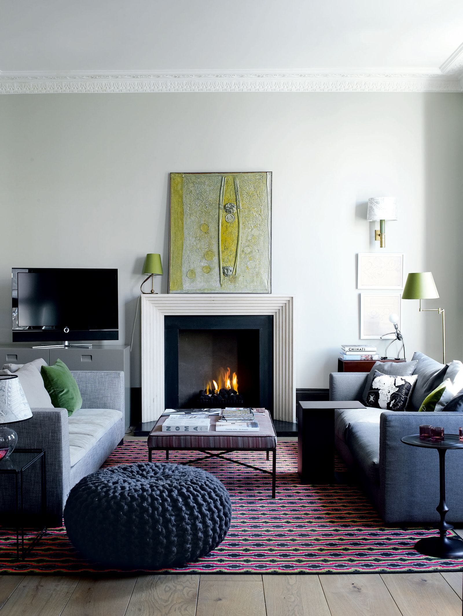 Image may contain Furniture Living Room Room Indoors Rug Interior Design Couch Fireplace Hearth Cushion and Pillow