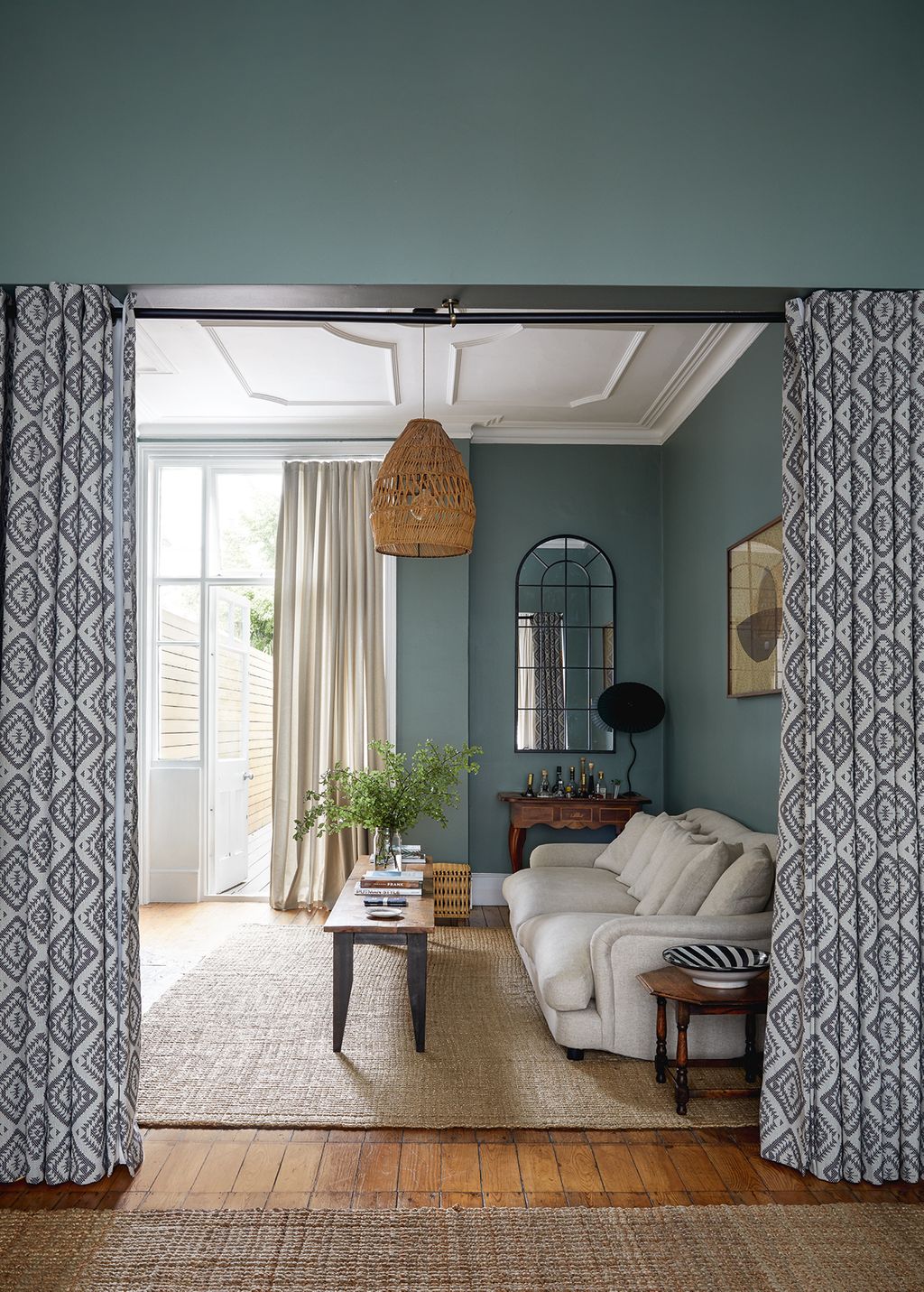 Geometricprint wool mix curtains from Peter Jones divide the sitting room in two. The sofa is from Loaf and the small...