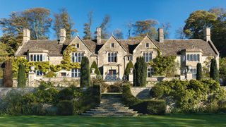 Image may contain Plant Grass Building Housing Villa House Mansion and Lawn