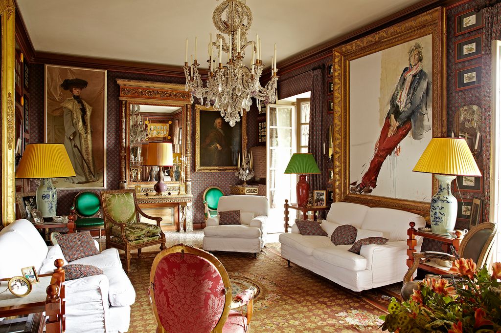 Image may contain Living Room Room Indoors Furniture Couch Lamp Chandelier Human Person and Interior Design