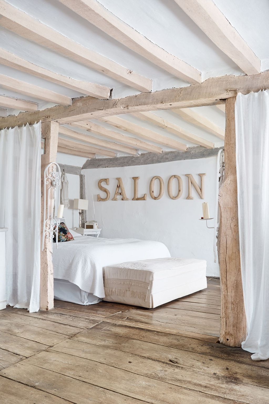 Image may contain Furniture Interior Design Indoors Room Bedroom Porch Wood Bed and Patio