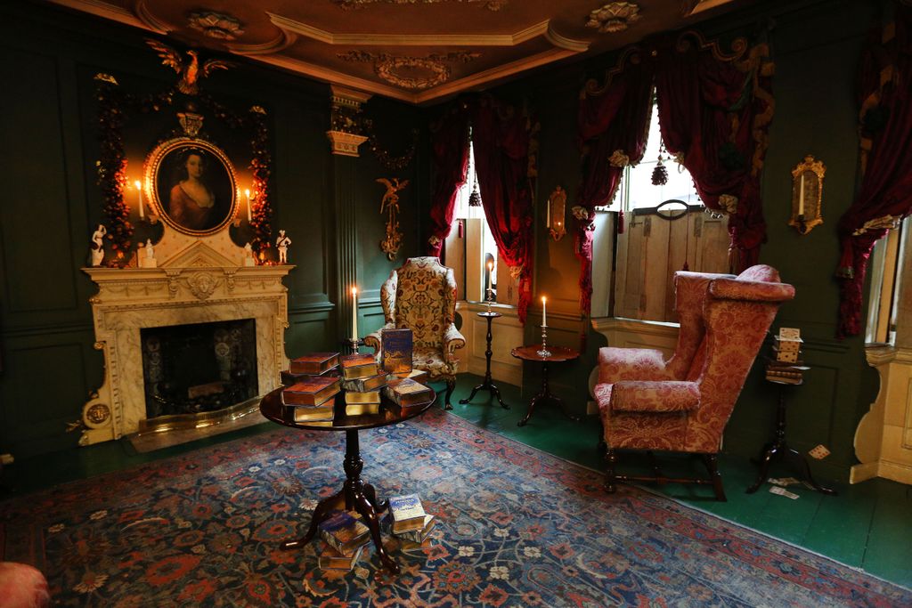 Image may contain Furniture Living Room Room Indoors Chair Fireplace Couch Flooring Human and Person