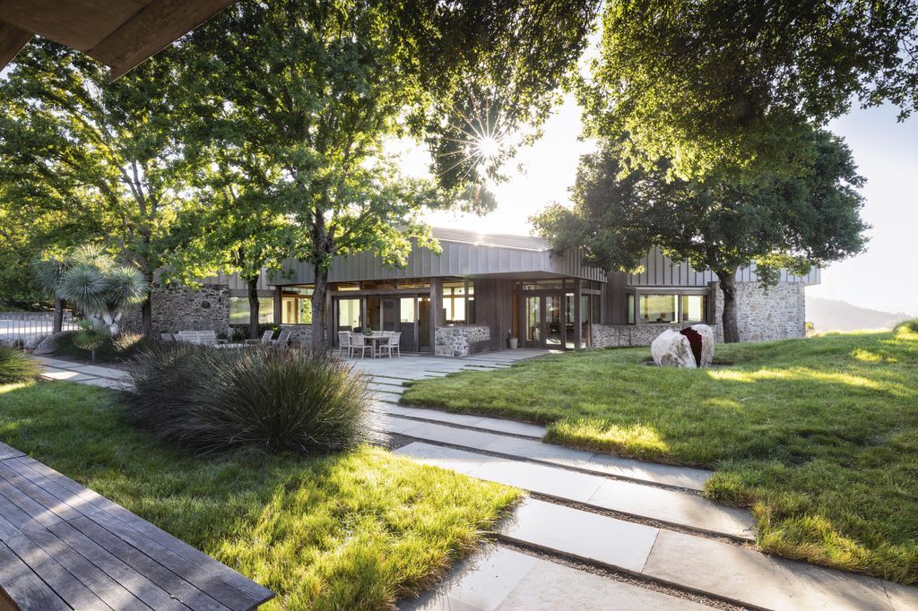 The link between the guesthouse and the main residence is softened by low plantings of Carex pansa.