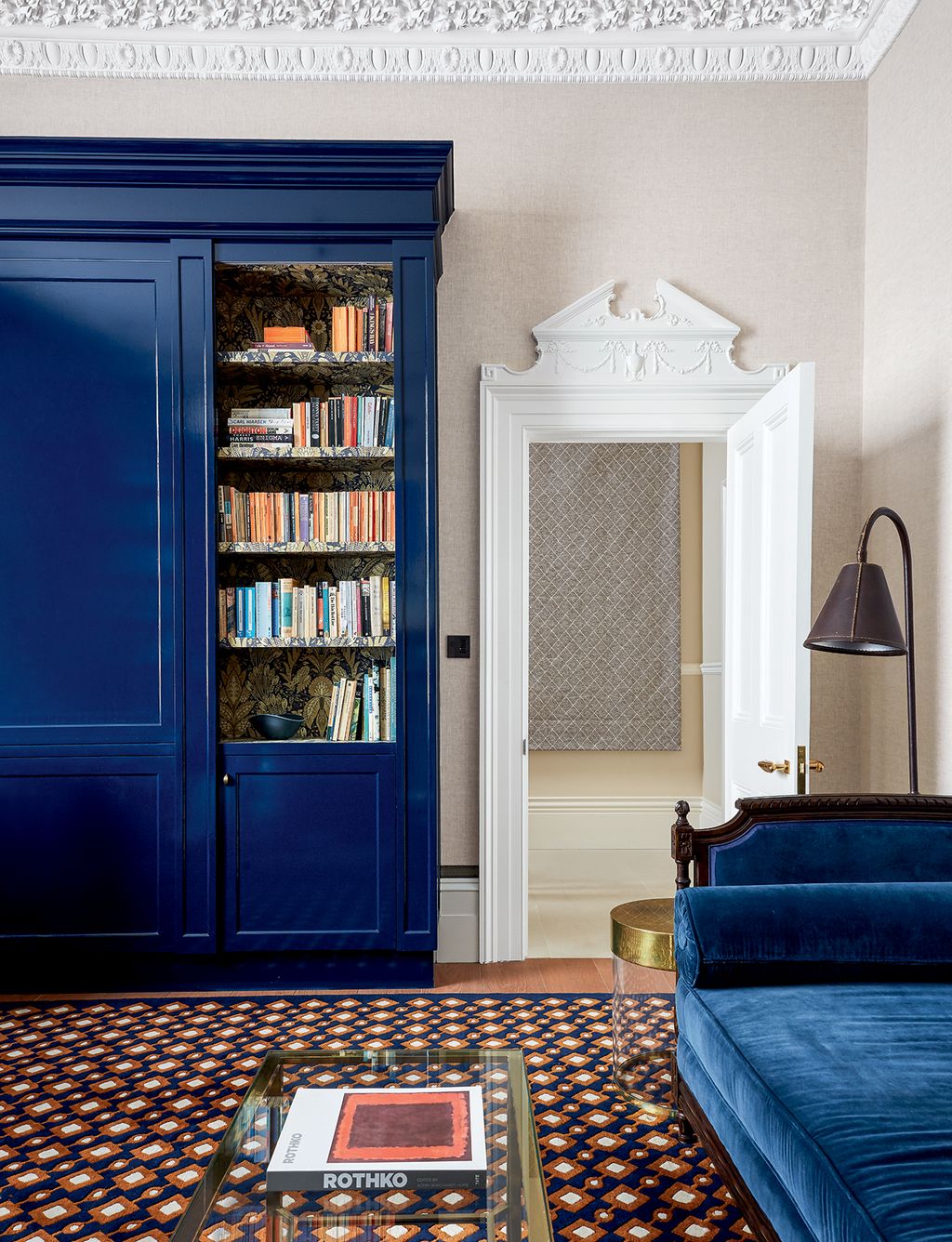 Image may contain Furniture Couch Living Room Indoors Room Bookcase Shelf Cupboard Closet Rug and Interior Design