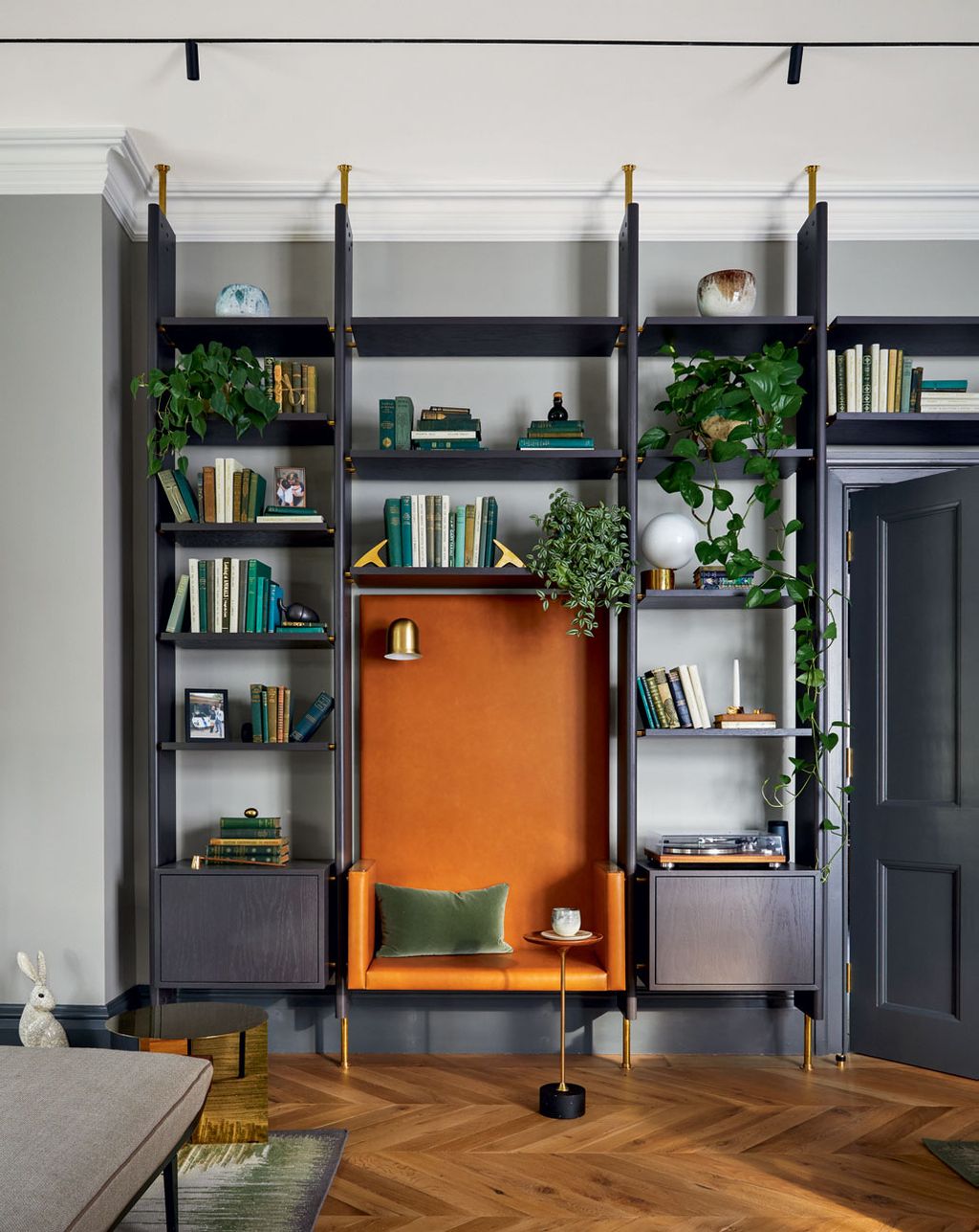 Image may contain Furniture Shelf Bookcase Wood Living Room Indoors and Room