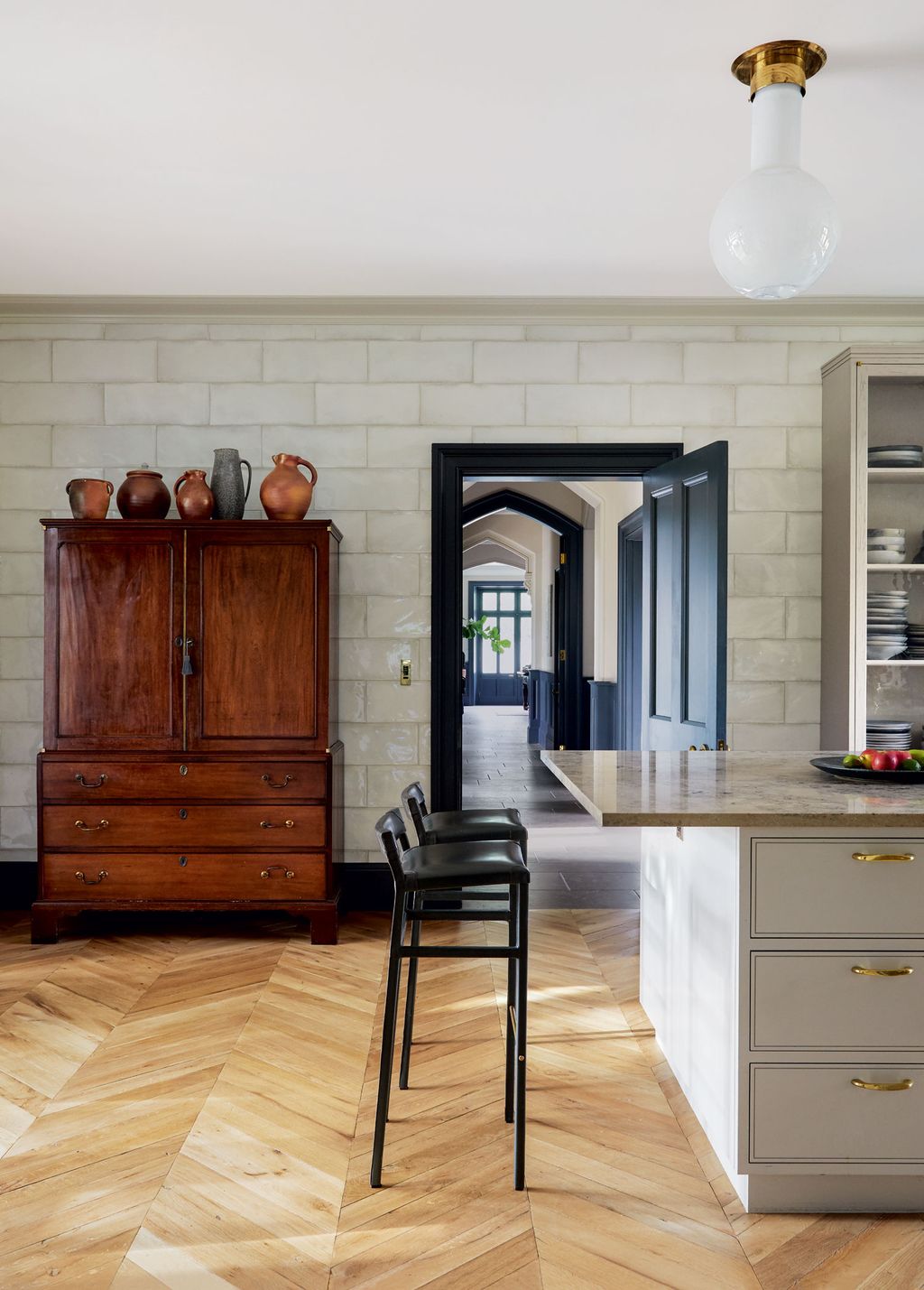 Wall tiles from Domus and parquet flooring from White White provide the backdrop for a Regency mahogany linen press and...