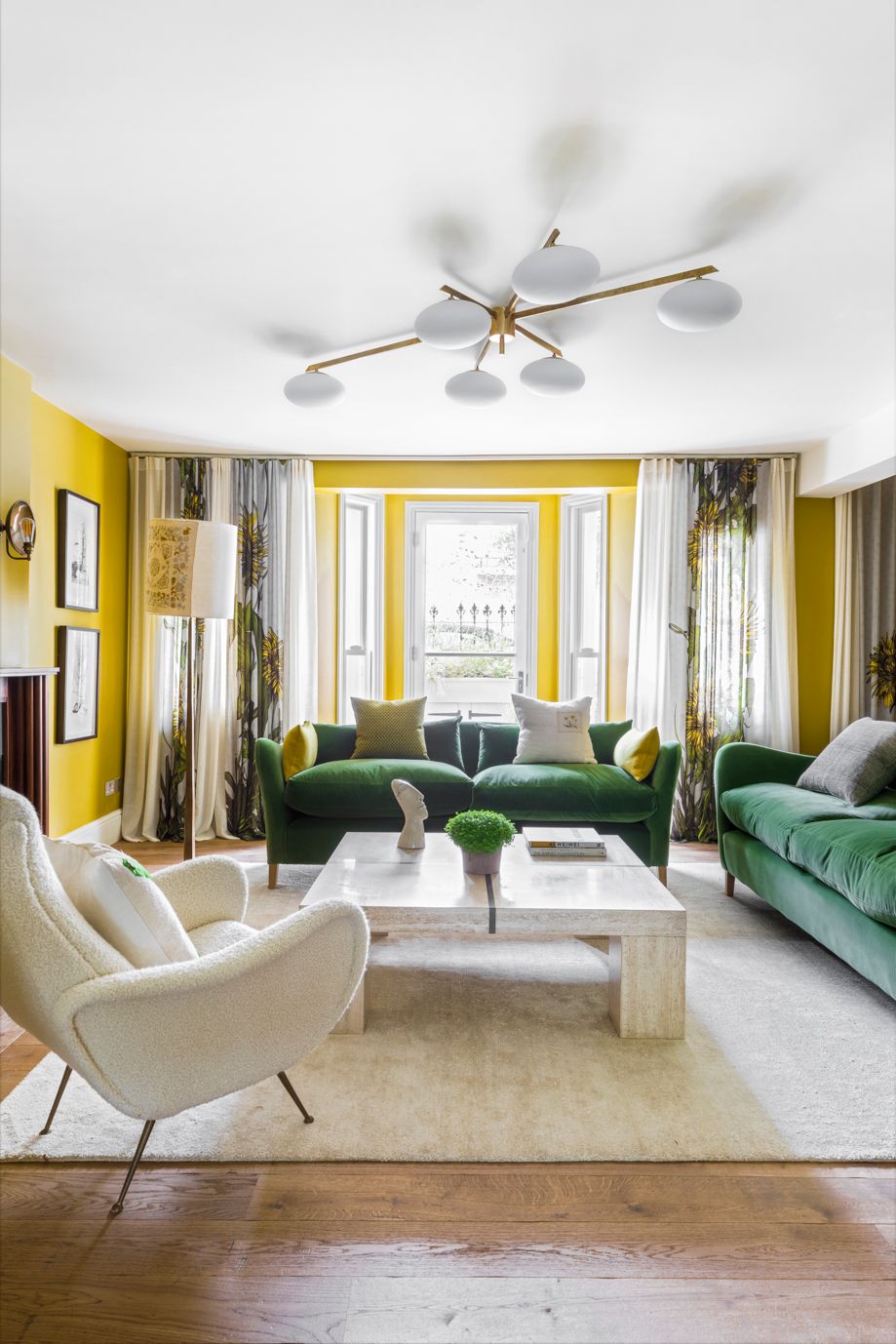 Image may contain Furniture Table Appliance Ceiling Fan Living Room Room Indoors Coffee Table Rug Chair and Couch