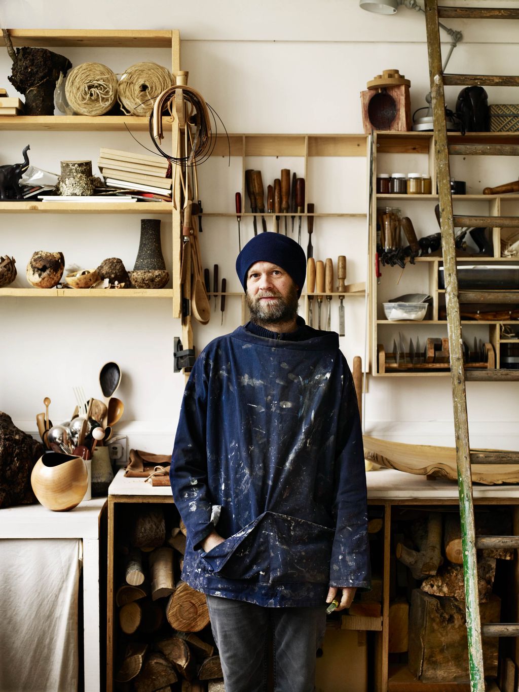 Image may contain Clothing Apparel Shelf Human Person Cutlery Spoon Wood and Coat