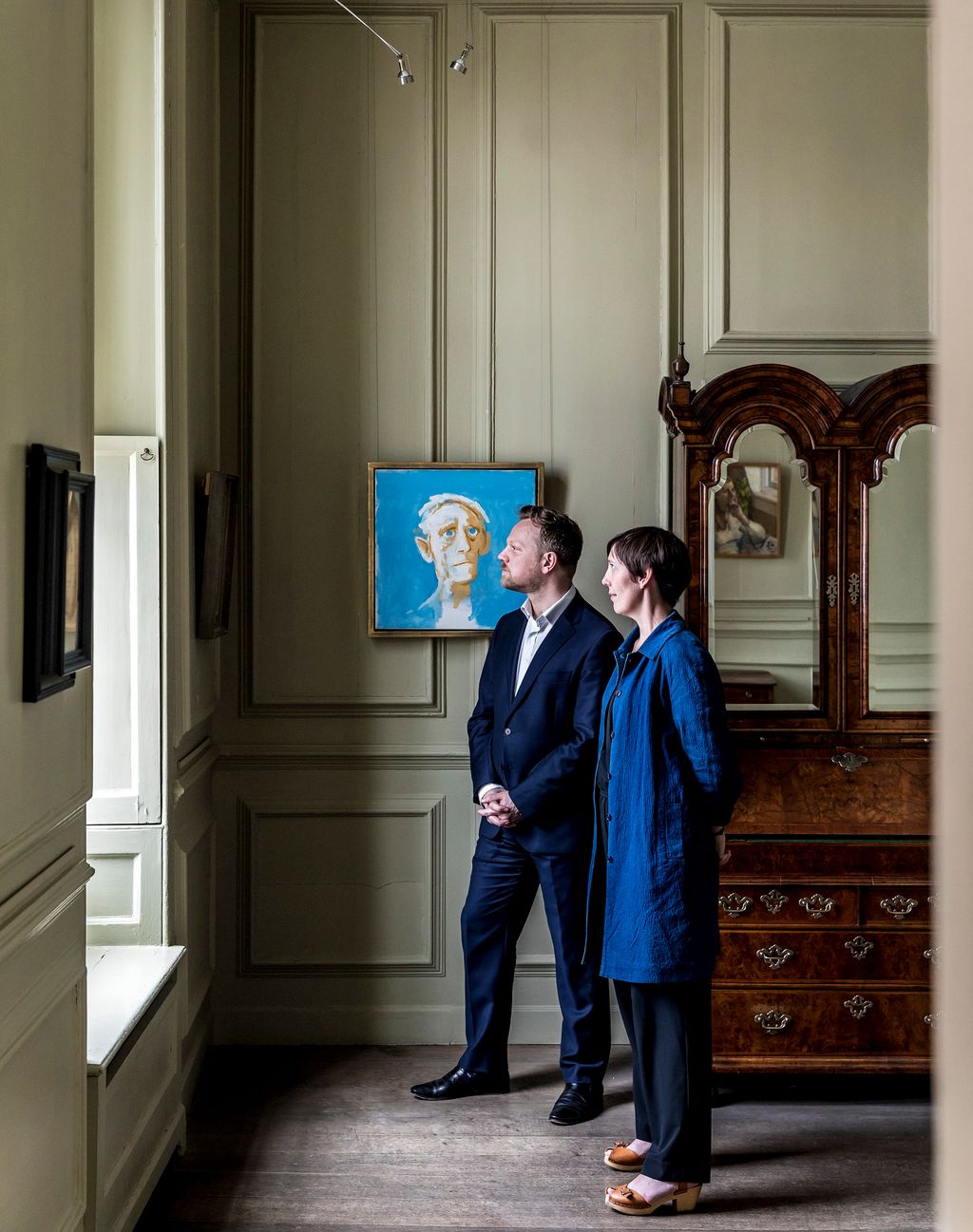 Image may contain Flooring Human Person Clothing Shoe Footwear Apparel Floor Furniture Suit Coat and Overcoat