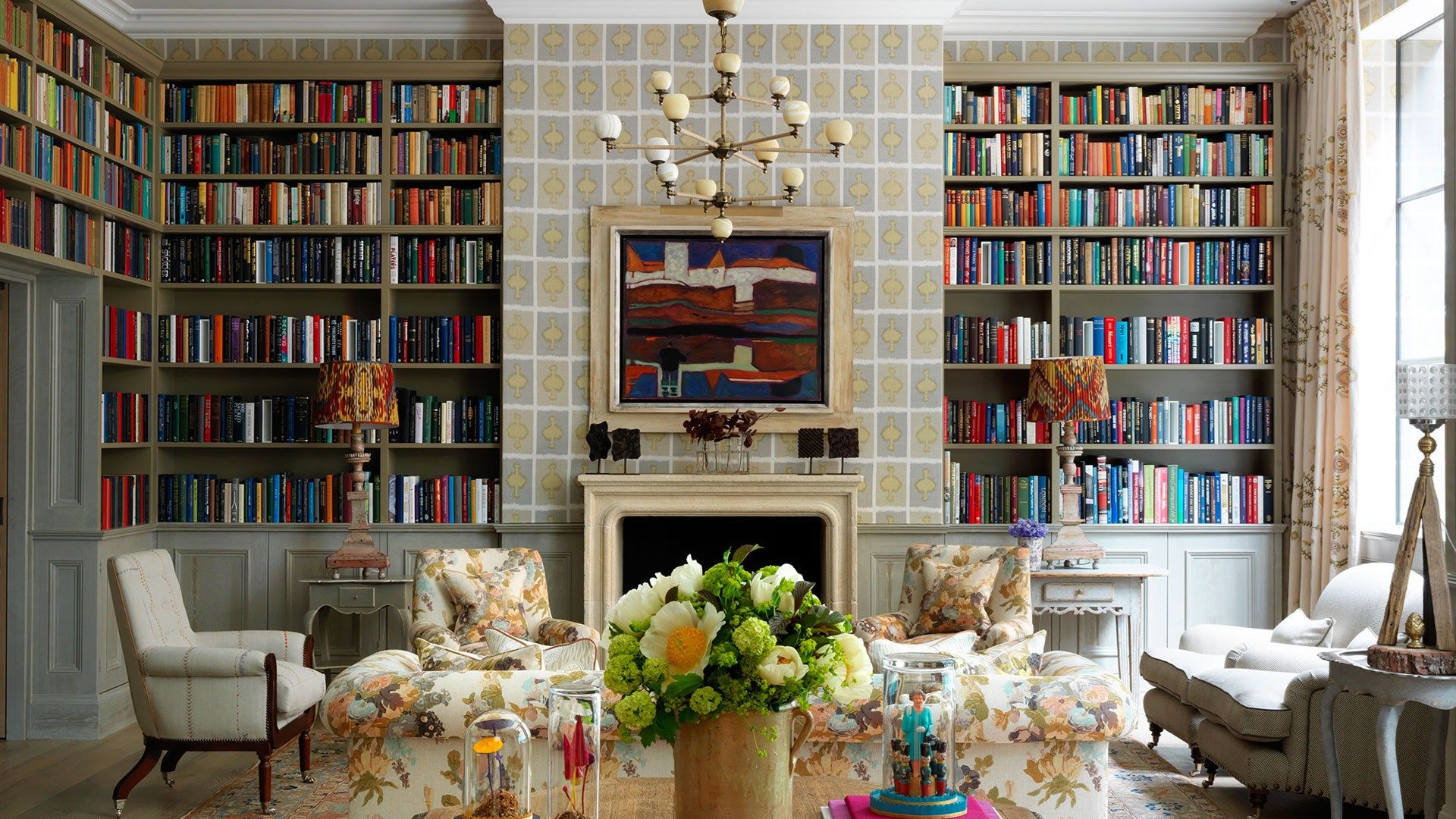 Image may contain Furniture Living Room Room Indoors Interior Design Bookcase Couch Plant Table Shelf and Flower