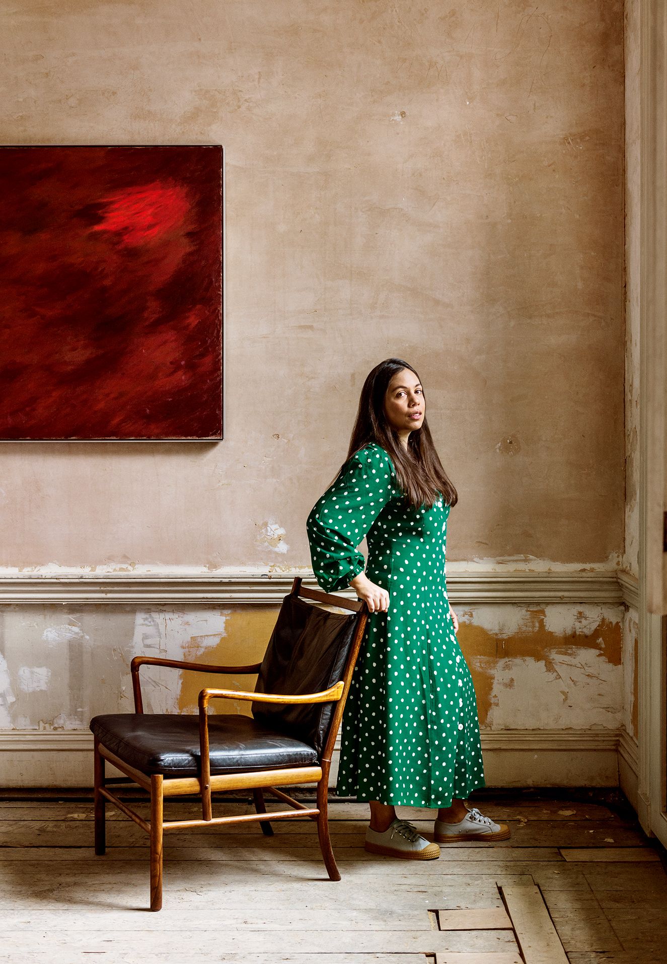 Image may contain Furniture Clothing Apparel Chair Human Person Flooring Wood Couch Sitting and Dress