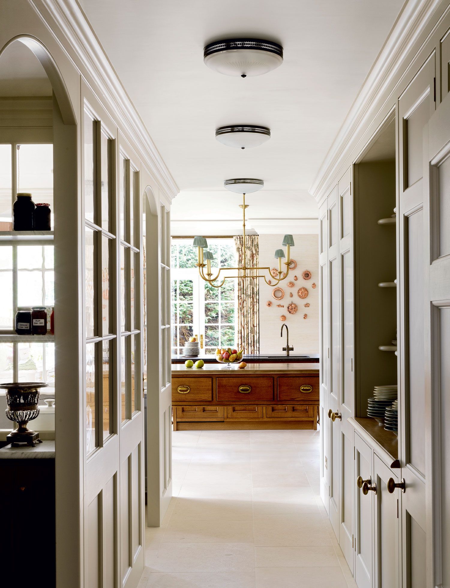 With bespoke units by Artichoke the kitchen includes a larder and butlers pantry with a passage lit by Vaughans...