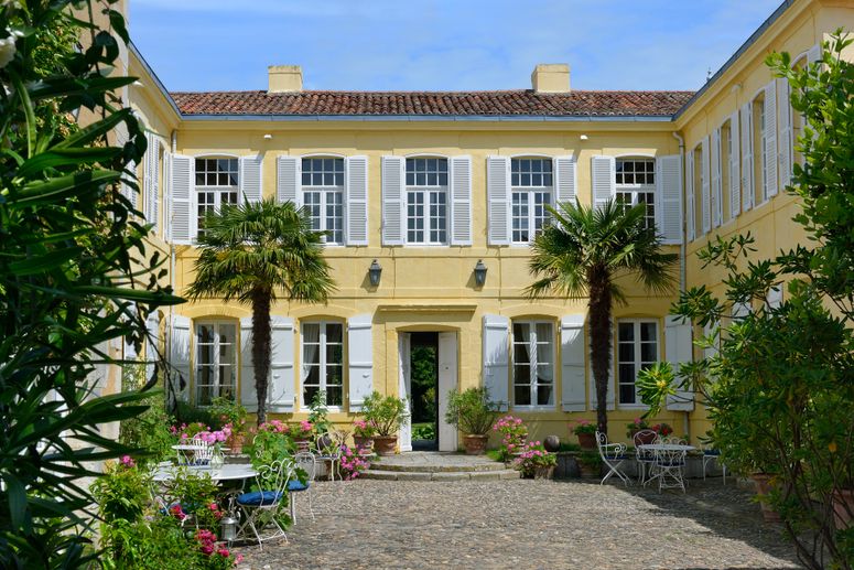 Image may contain: Path, Walkway, Flagstone, Vase, Plant, Pottery, Potted Plant, Jar, Housing, Building, and Sidewalk