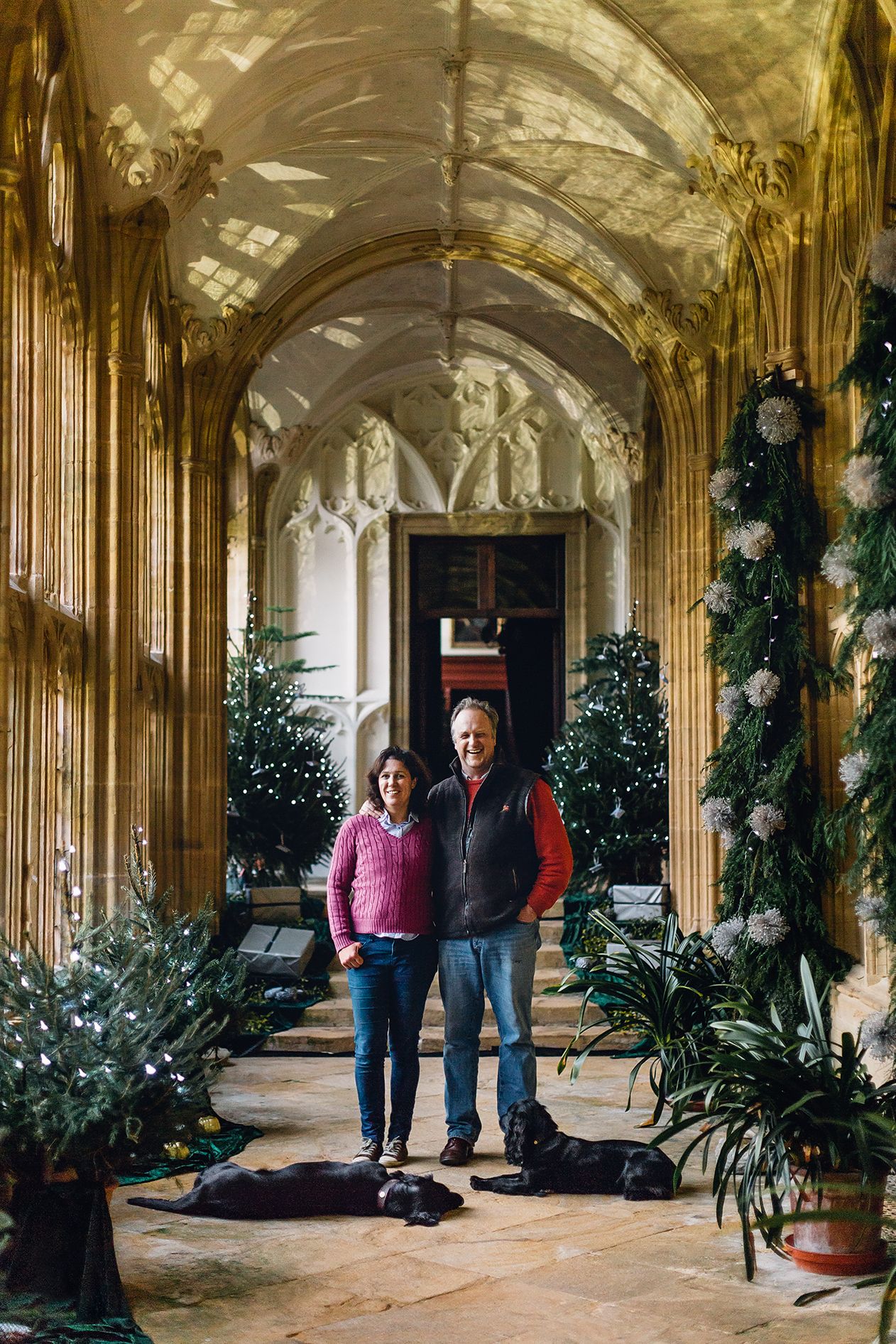 Alice and Julian in the cloisters with flatcoat retriever Quenta and spaniel Pixel.