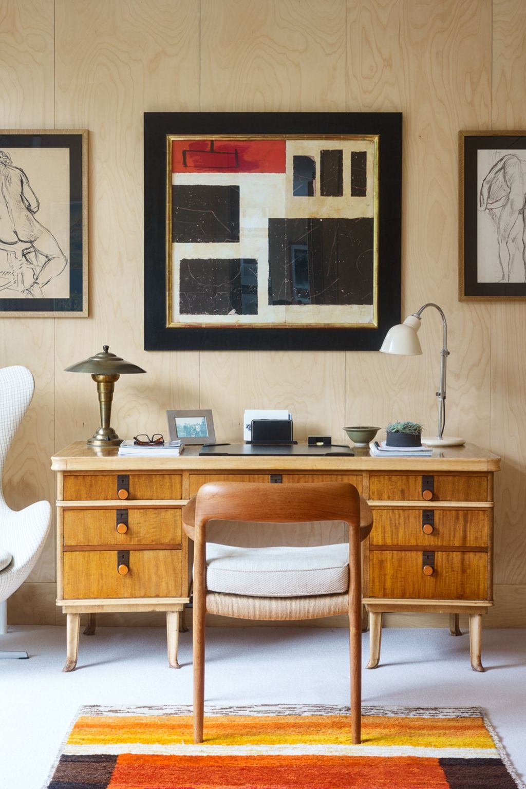 A brightly coloured wooden desk brings out the room's colour.