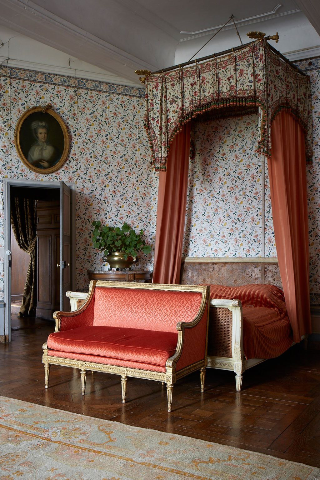 Image may contain Furniture Couch Living Room Room Indoors Home Decor Rug Flooring Human Person and Wood