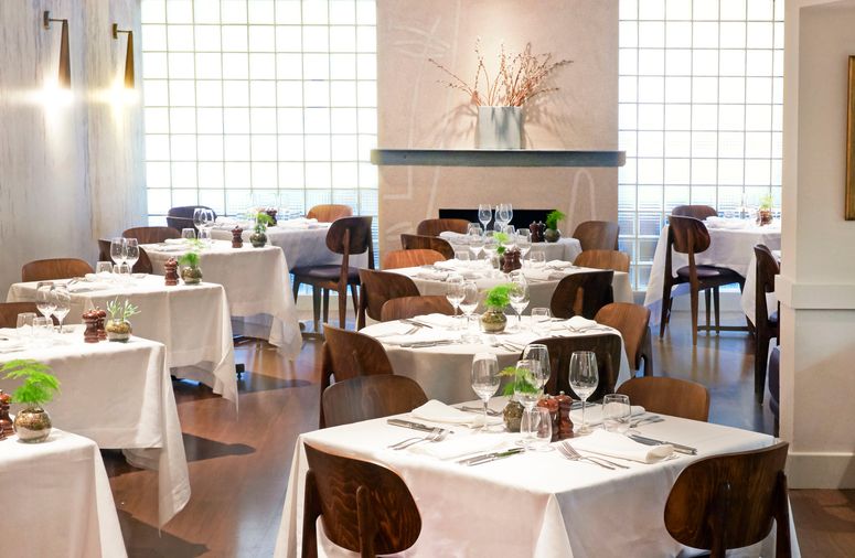 Image may contain: Furniture, Dining Table, Table, Tablecloth, Chair, Restaurant, Room, Indoors, and Wood