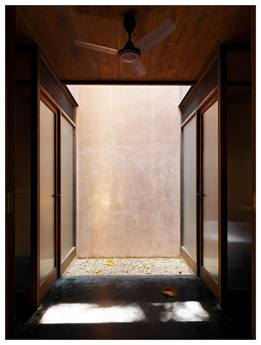 Image may contain Corridor Flooring Appliance Ceiling Fan Floor Lighting and Door