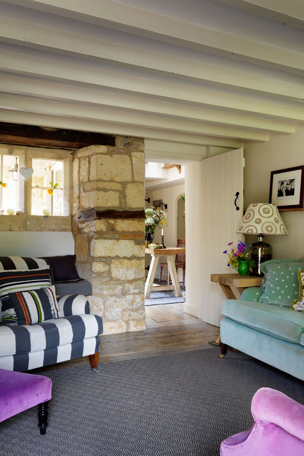 Image may contain Living Room Room Indoors Furniture Couch Cushion Interior Design Flooring Human and Person