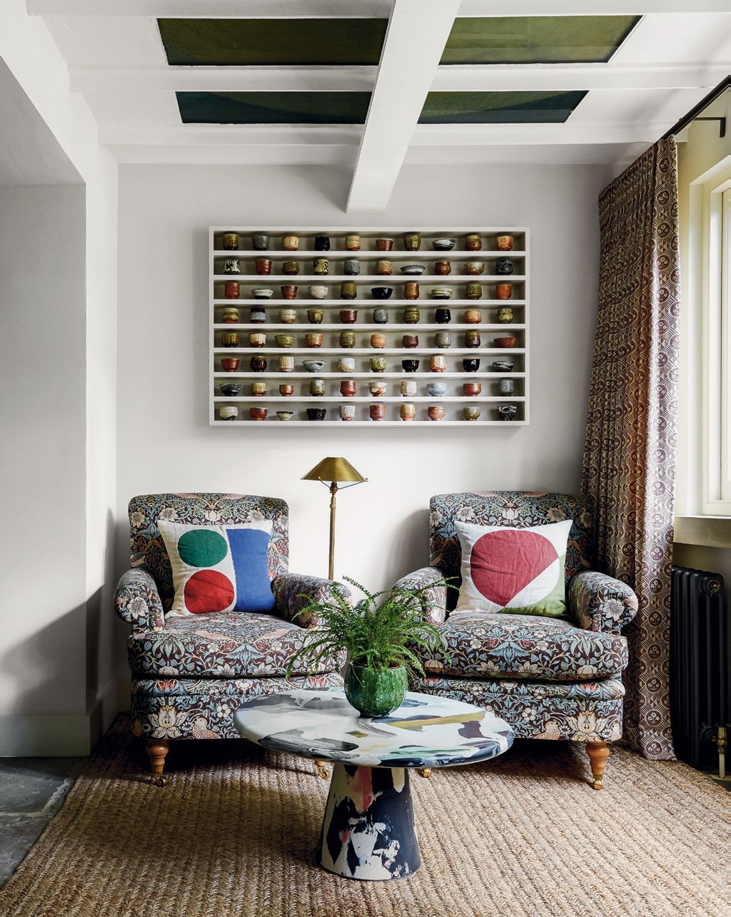 Image may contain Living Room Room Indoors Furniture Couch Cushion Table Rug Coffee Table and Shelf