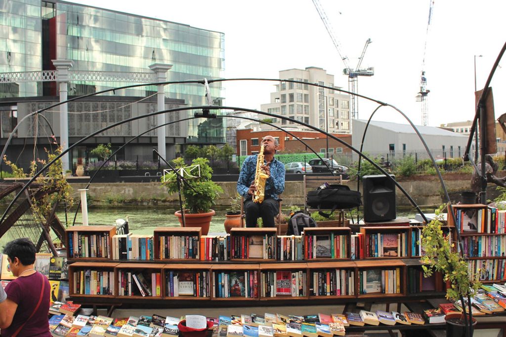 Image may contain Human Person Furniture Indoors Shop Shelf Bookcase Book Bookstore Light and Traffic Light