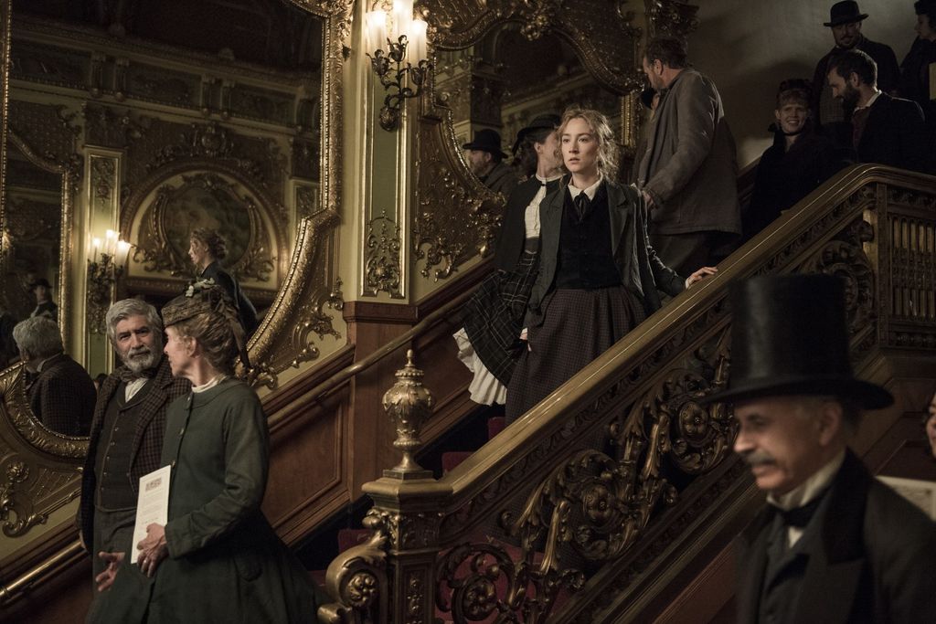 Image may contain Banister Handrail Human Person Saoirse Ronan Clothing Hat Apparel Suit Overcoat and Coat