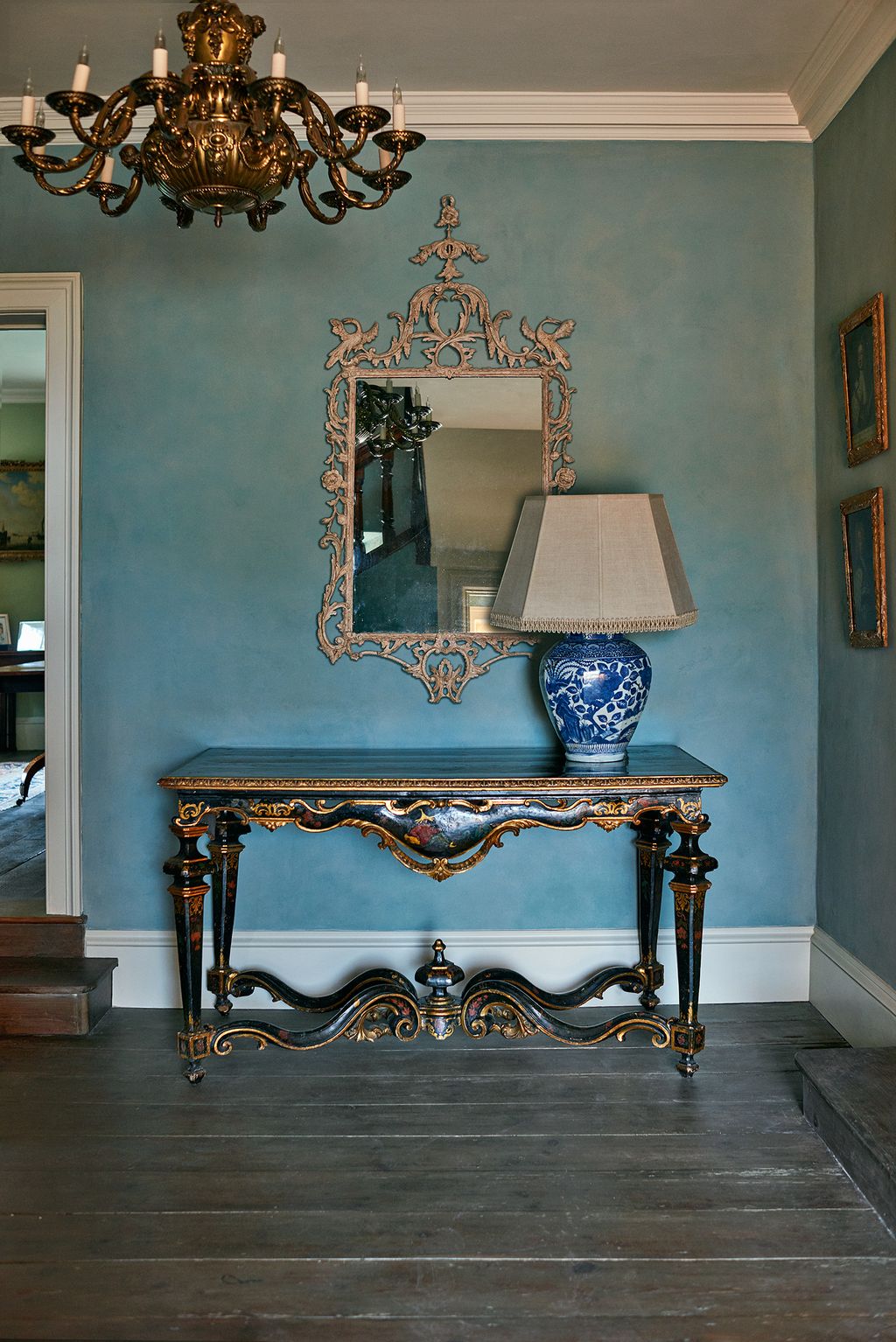 Image may contain Wood Flooring Furniture Hardwood Interior Design Indoors Lamp Table Lamp Floor and Chandelier