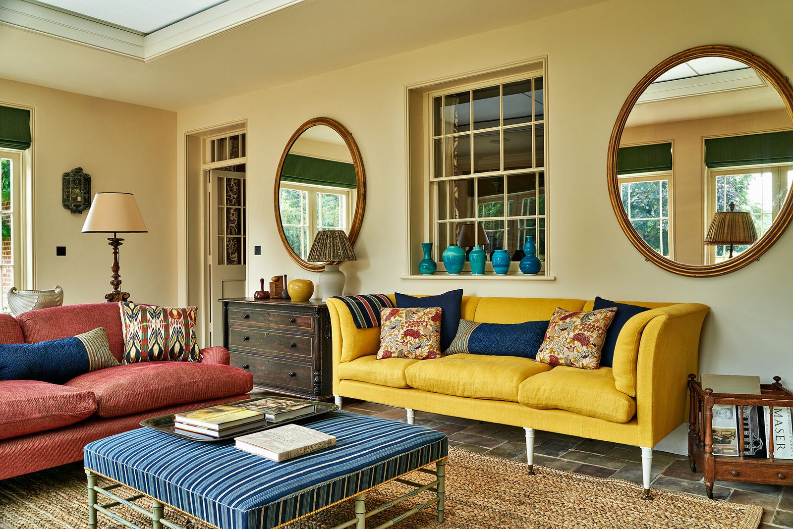 Large mirrors reflect the light in an Oxfordshire farmhouse by Max Rollitt