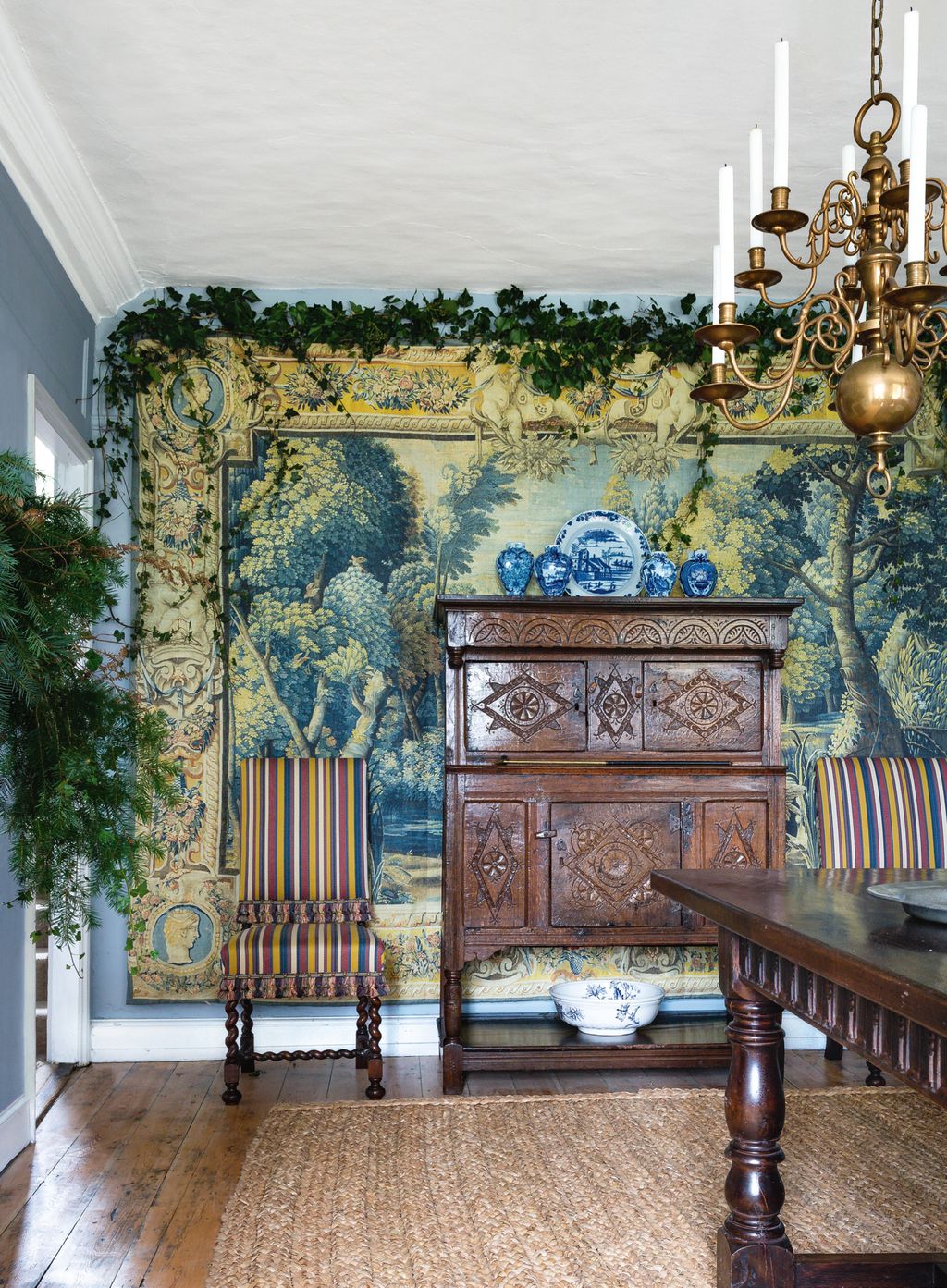 The chairs are covered in Robert Kimes cottonmix ‘Turkoman Stripe. Carlos bought the brass chandelier locally. A...