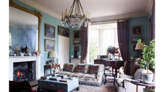 Image may contain Living Room Room Indoors Furniture Couch Lamp Chandelier Interior Design and Rug