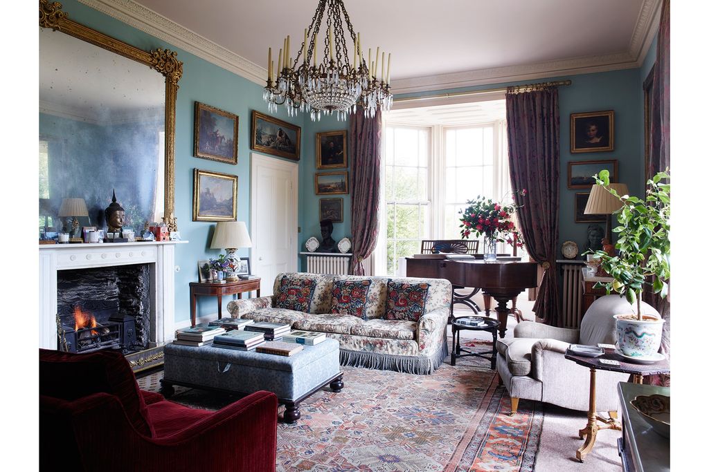 Image may contain Living Room Room Indoors Furniture Couch Lamp Chandelier Interior Design and Rug