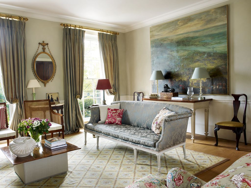 Image may contain Living Room Room Indoors Furniture Couch Interior Design Rug Flooring Table and Home Decor