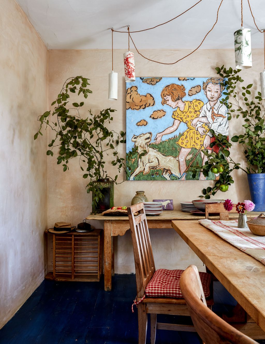 A painting by Australian artist David Bromley and handthrown china lights add distinctive touches. The antique table is...