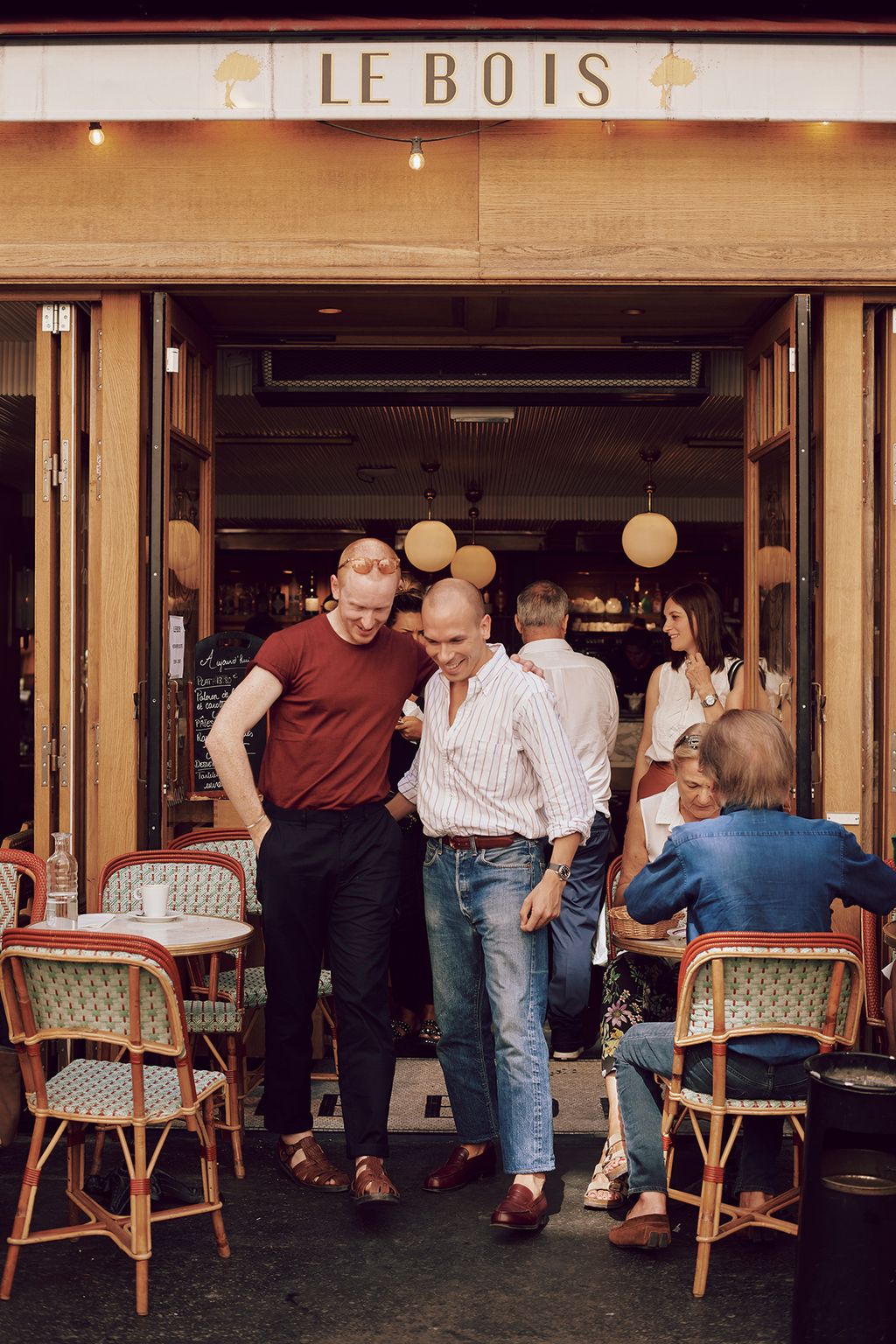 Image may contain Human Person Restaurant Footwear Clothing Shoe Apparel Pants Denim Jeans Furniture and Chair