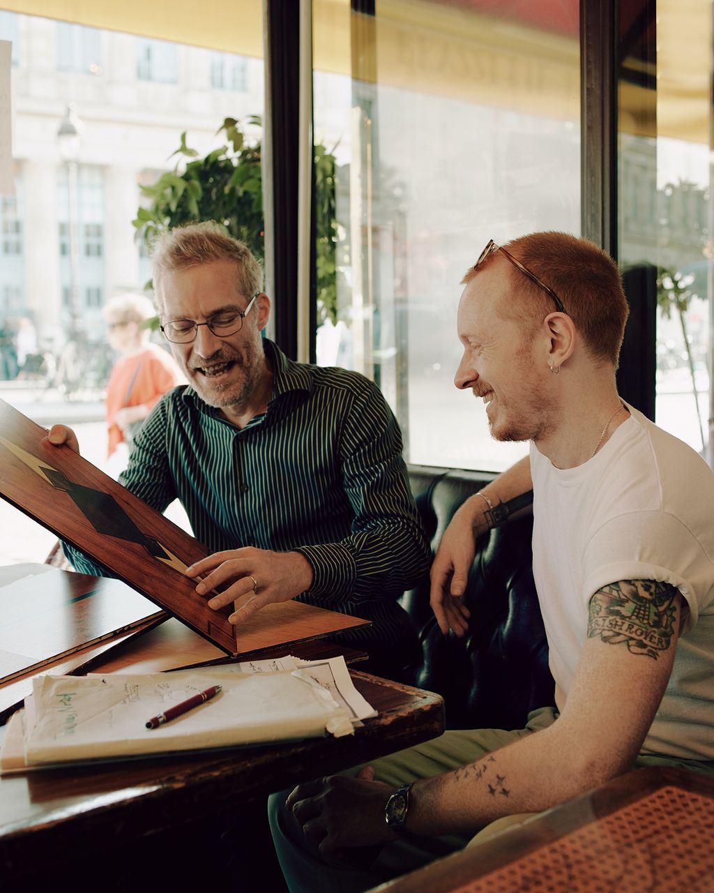 Image may contain Human Person Wood Sitting Plywood Skin Footwear Clothing Shoe and Apparel