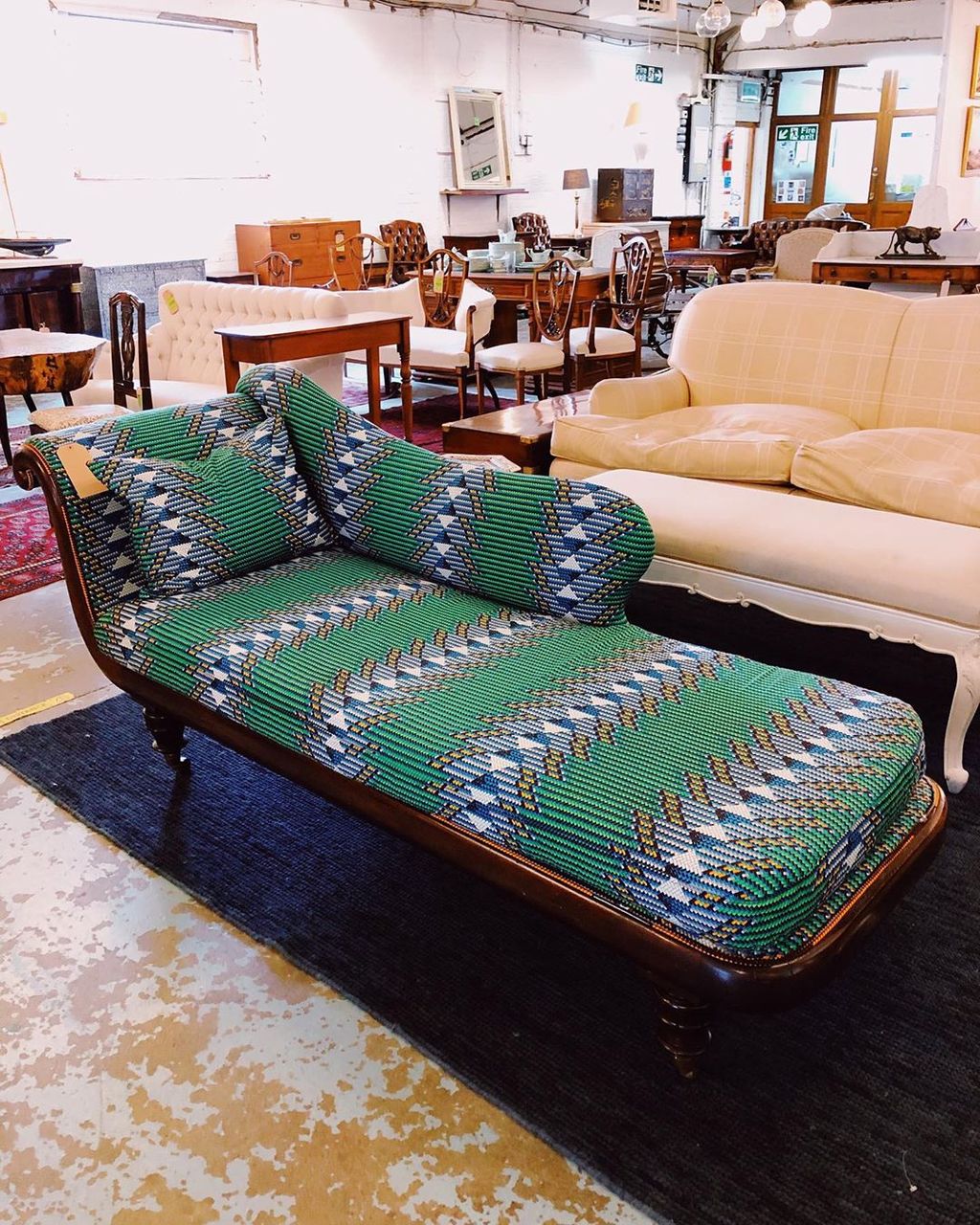 Image may contain Furniture Couch Rug Home Decor Room Indoors Lobby Chair and Living Room