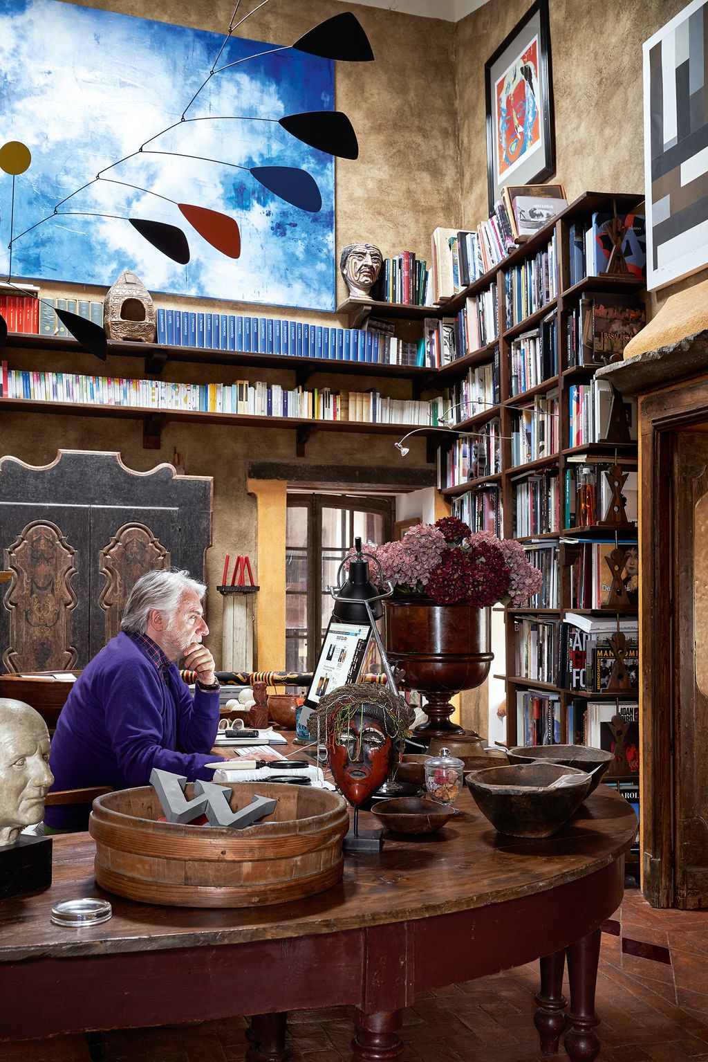 Paolo works under an Alexander Calder mobile in his treasurefilled office.