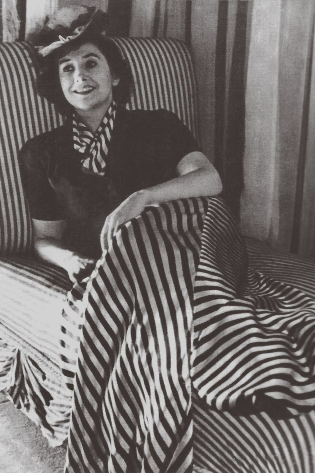 Image may contain Blanket Cushion Pillow Clothing Apparel Furniture Human Person Face and Bed