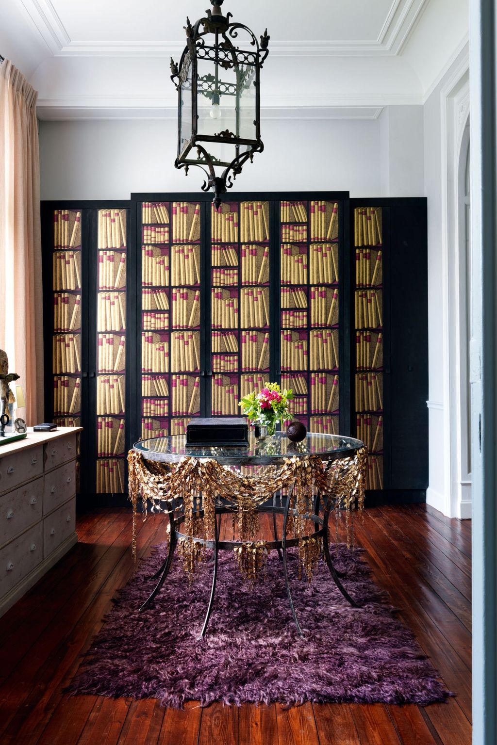 Image may contain Wood Flooring Hardwood Furniture Floor Interior Design Indoors Rug Shelf Living Room and Room