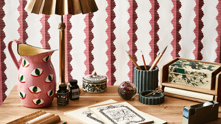 Image may contain Furniture Tabletop Table Rug Lamp Table Lamp and Desk