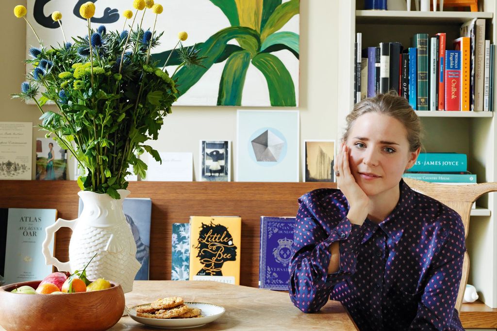 Image may contain Human Person Furniture Wood Home Decor Shelf and Plant